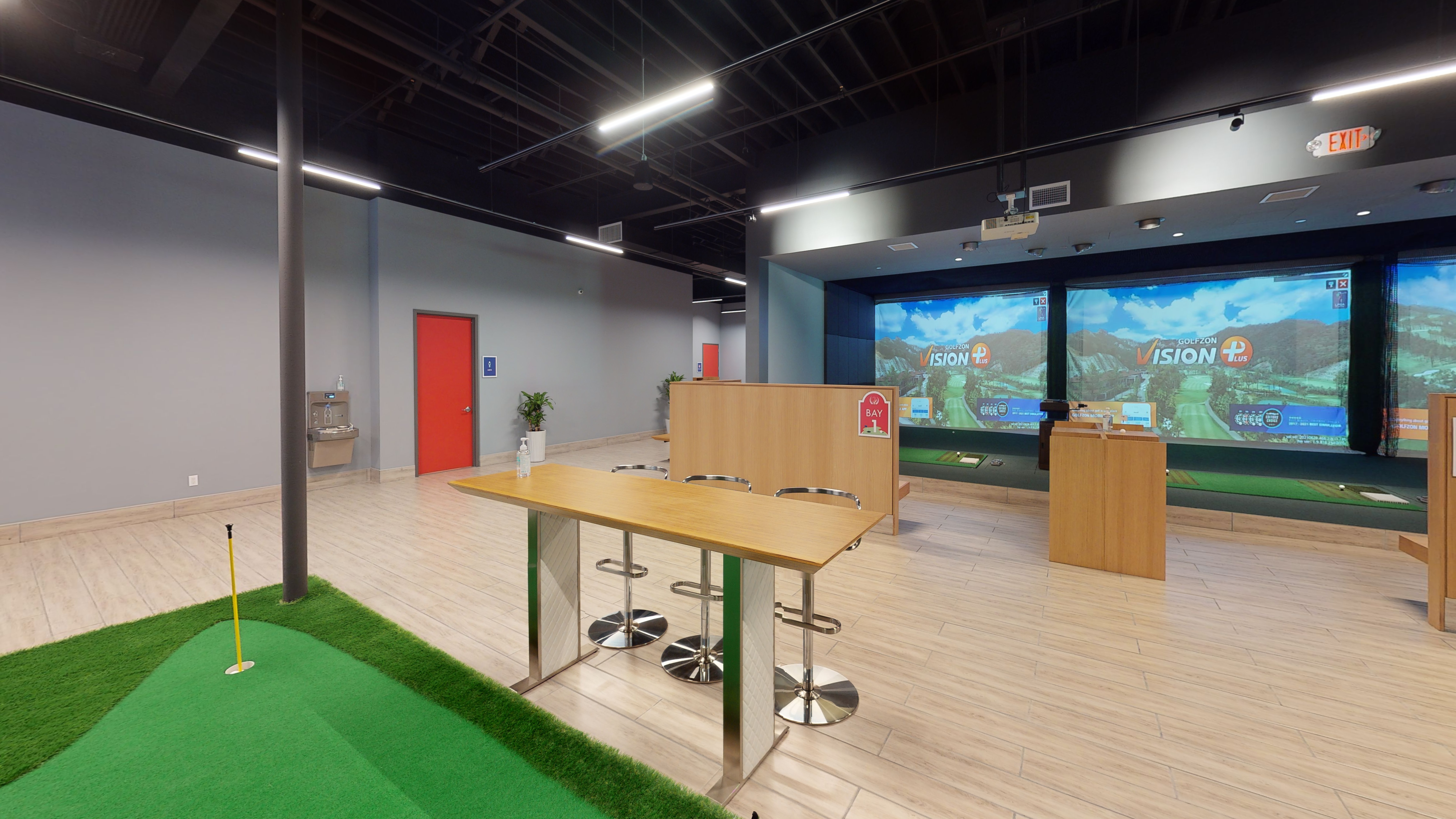 Golfzon simulator setup inside a basement for design ideas