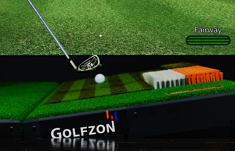 A closeup of Golfzon golf club and golf ball on top of swing plate.